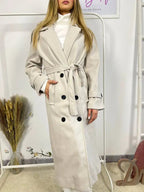 This double-breasted coat features button closure, a built-in belt, and practical pockets, showcasing refined elegance and versatile practicality