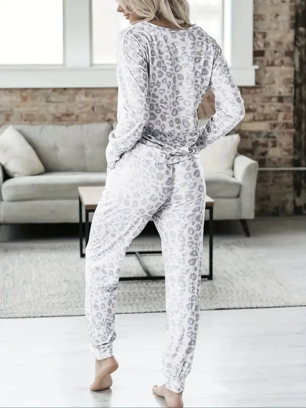 Women's V-NeckLeopard Print Loungewear Set. This relaxed-fit two-piece features a short-sleeve top and pants for effortlessly chic, casual comfort.