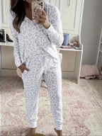 Women's V-NeckLeopard Print Loungewear Set. This relaxed-fit two-piece features a short-sleeve top and pants for effortlessly chic, casual comfort.