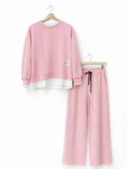 Women's tracksuit: hoodie and sweatpants, casual wear, simple straight-leg style.