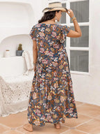 A-line dress with butterfly sleeves, belt, ruffled hem, and floral print