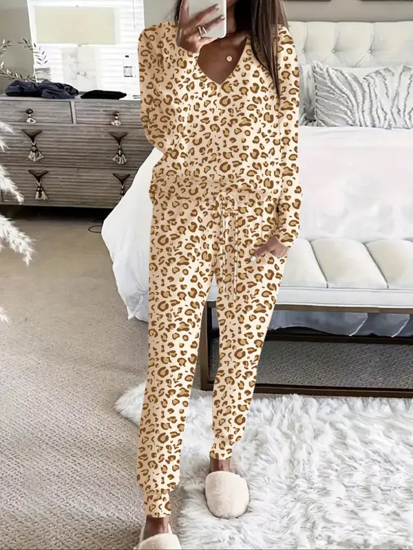 Women's V-NeckLeopard Print Loungewear Set. This relaxed-fit two-piece features a short-sleeve top and pants for effortlessly chic, casual comfort.