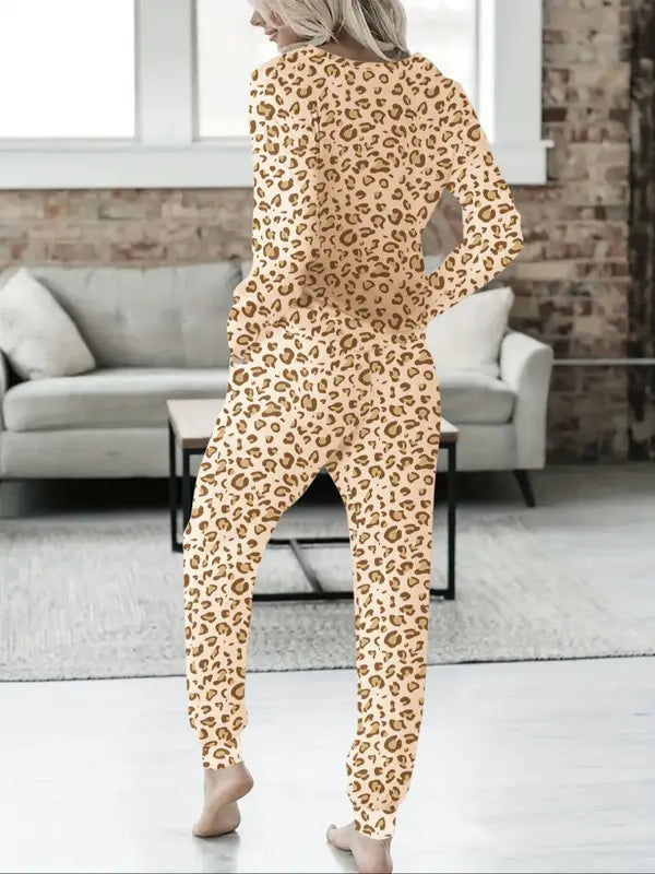 Women's V-NeckLeopard Print Loungewear Set. This relaxed-fit two-piece features a short-sleeve top and pants for effortlessly chic, casual comfort.