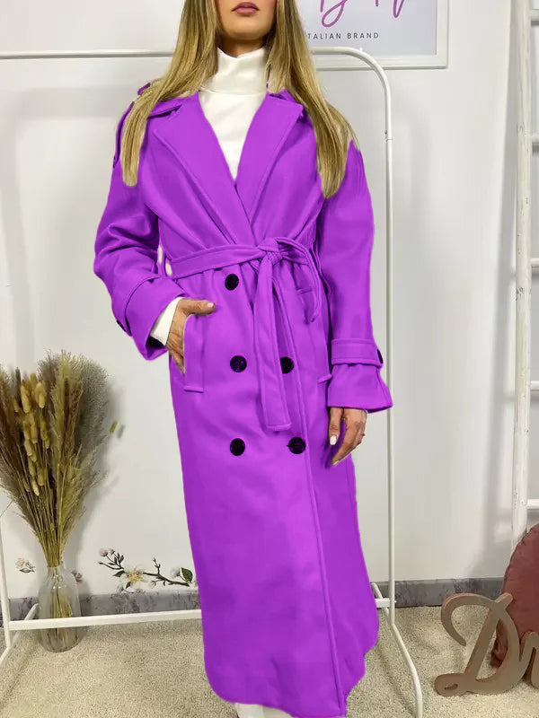 This double-breasted coat features button closure, a built-in belt, and practical pockets, showcasing refined elegance and versatile practicality
