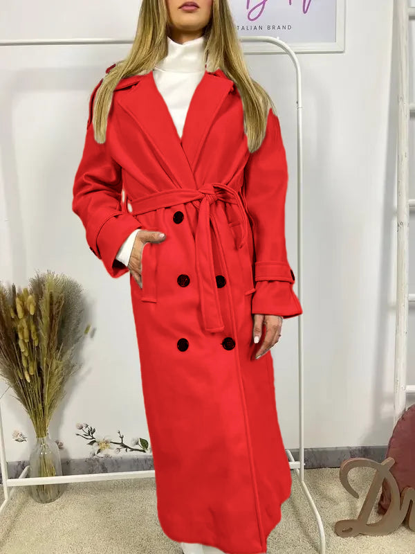 This double-breasted coat features button closure, a built-in belt, and practical pockets, showcasing refined elegance and versatile practicality