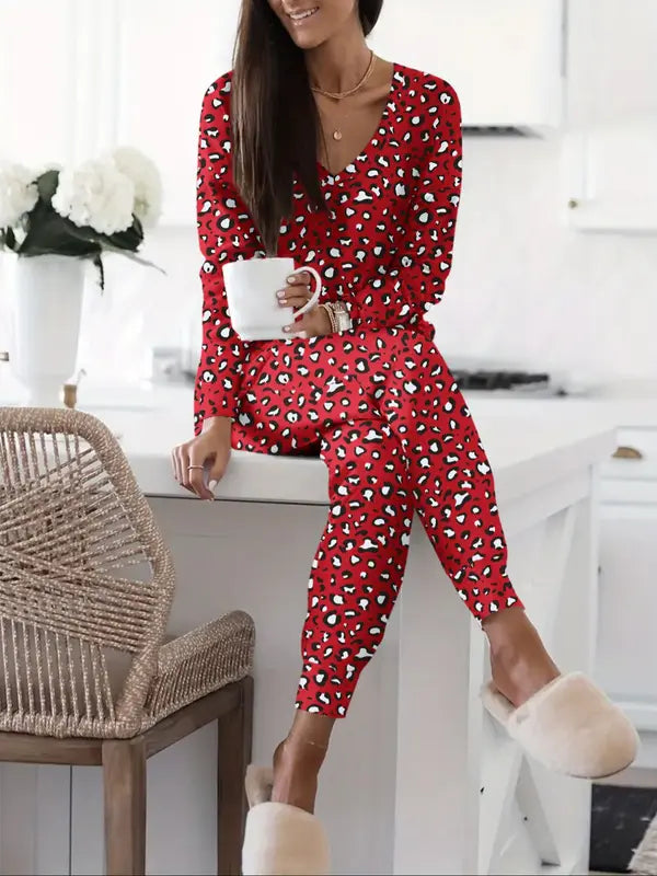 Women's V-NeckLeopard Print Loungewear Set. This relaxed-fit two-piece features a short-sleeve top and pants for effortlessly chic, casual comfort.