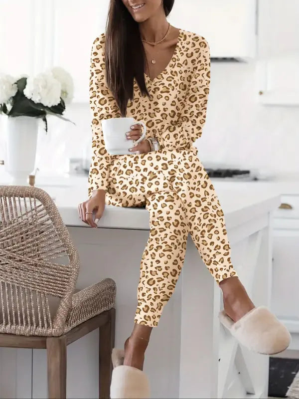 Women's V-NeckLeopard Print Loungewear Set. This relaxed-fit two-piece features a short-sleeve top and pants for effortlessly chic, casual comfort.