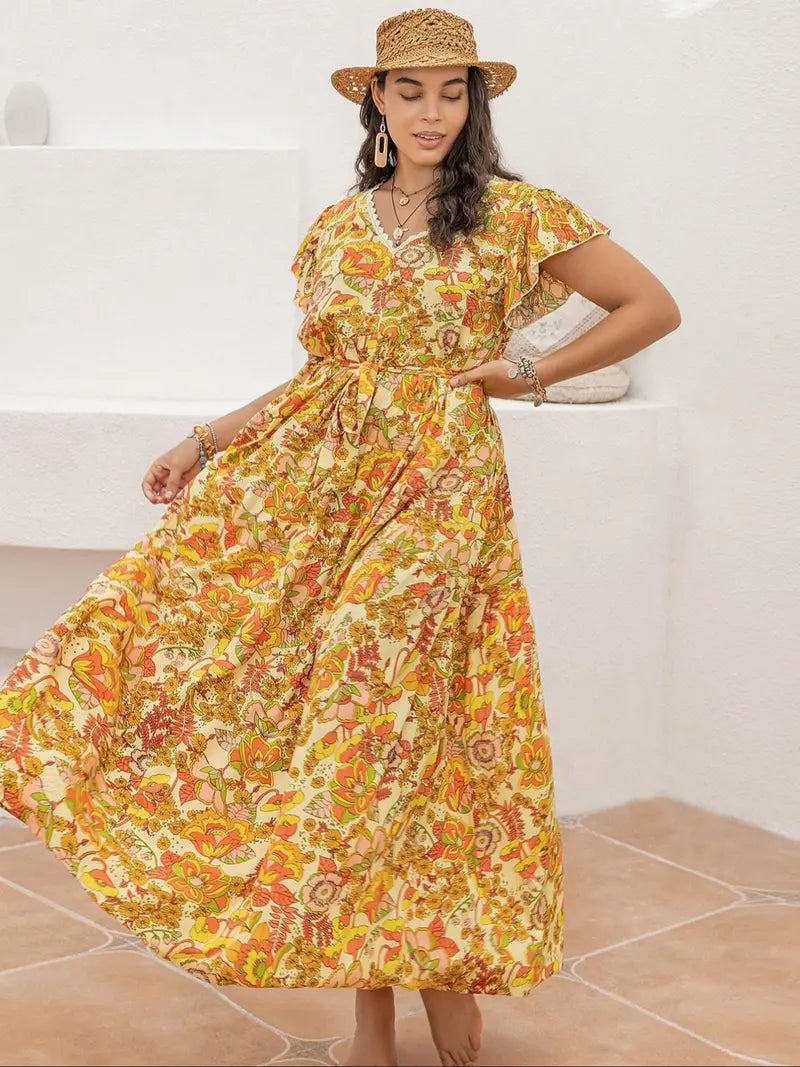 A-line dress with butterfly sleeves, belt, ruffled hem, and floral print