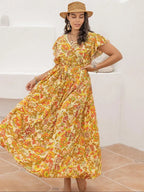 A-line dress with butterfly sleeves, belt, ruffled hem, and floral print
