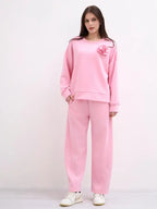 This two-piece wetsuit set, made of wetsuit viscose fabric, includes a shirt adorned with a flower brooch and a pair of elasticated harem pants.