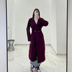 Coat with a belt at the waist