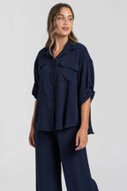 Two-piece set: loose-fitting shirt-style top, loose-fitting trousers, elastic waistband.