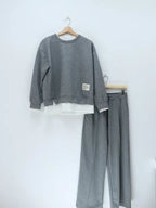 Women's tracksuit: hoodie and sweatpants, casual wear, simple straight-leg style.