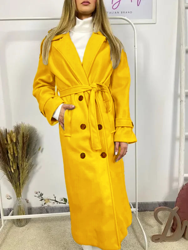 This double-breasted coat features button closure, a built-in belt, and practical pockets, showcasing refined elegance and versatile practicality