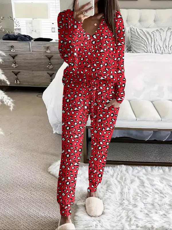 Women's V-NeckLeopard Print Loungewear Set. This relaxed-fit two-piece features a short-sleeve top and pants for effortlessly chic, casual comfort.