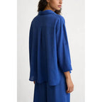 Two-piece set: loose-fitting shirt-style top, loose-fitting trousers, elastic waistband.