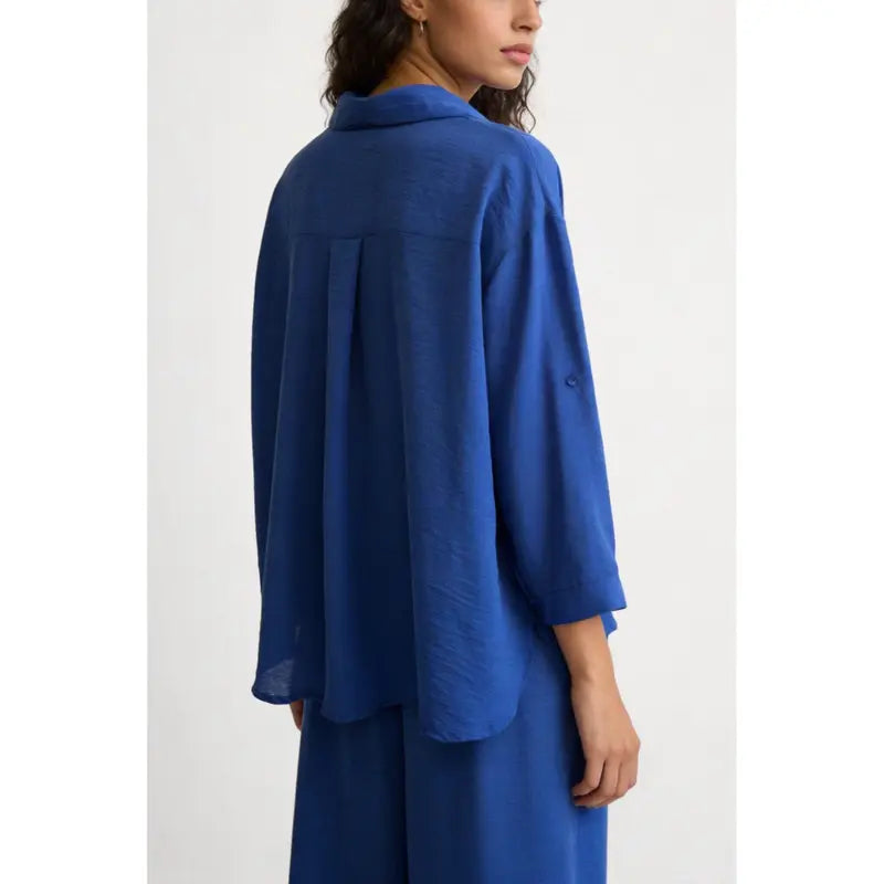 Two-piece set: loose-fitting shirt-style top, loose-fitting trousers, elastic waistband.